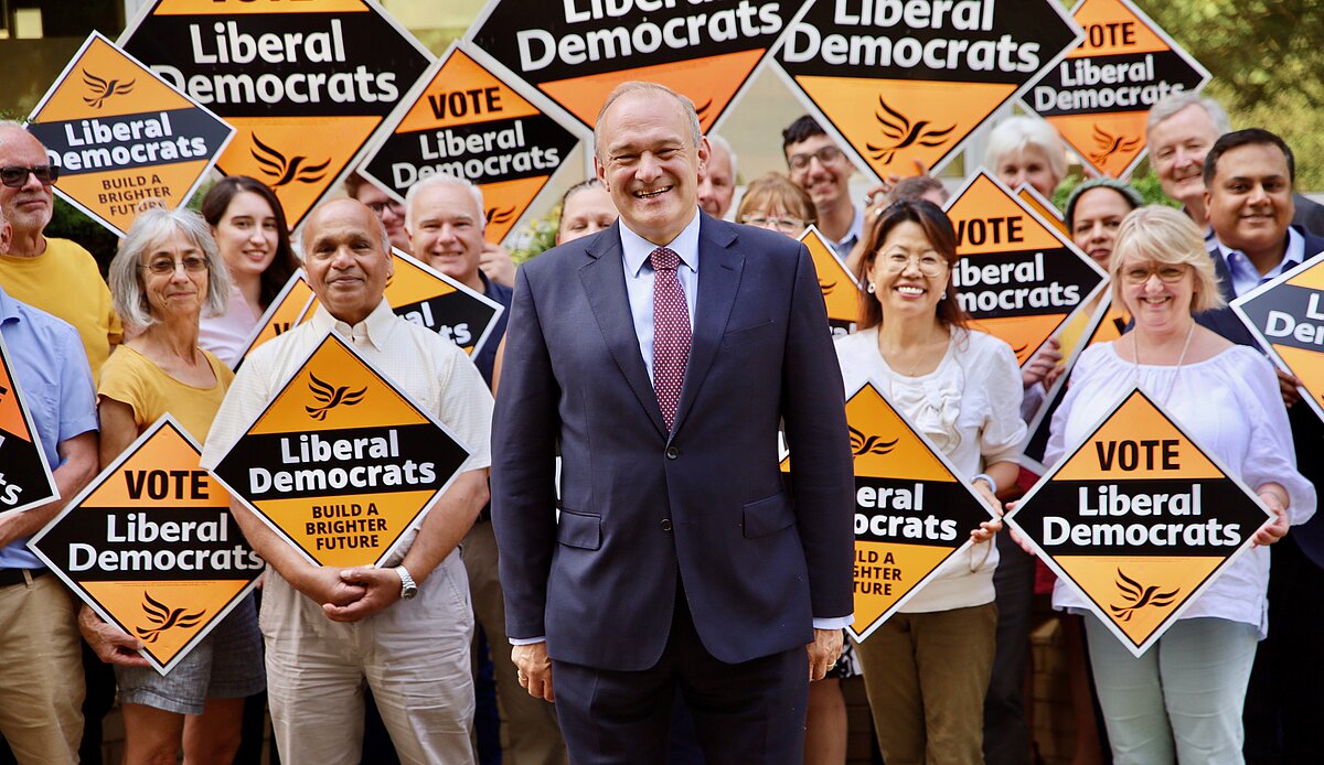 Ed Davey with a crowd holding Lib Dem signs
