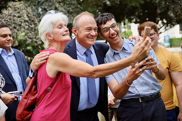 People take a selfie with Ed Davey