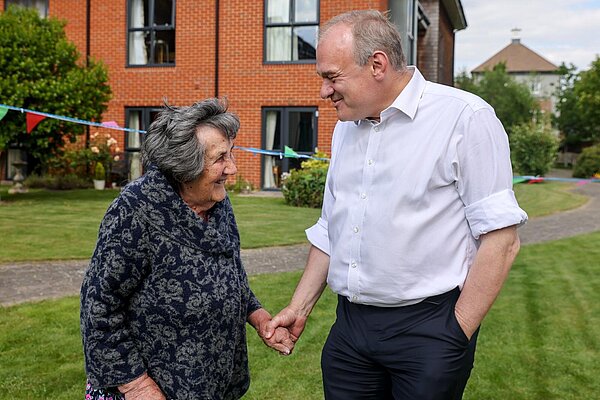 Ed Davey speaks to an older woman outside in Hampshire