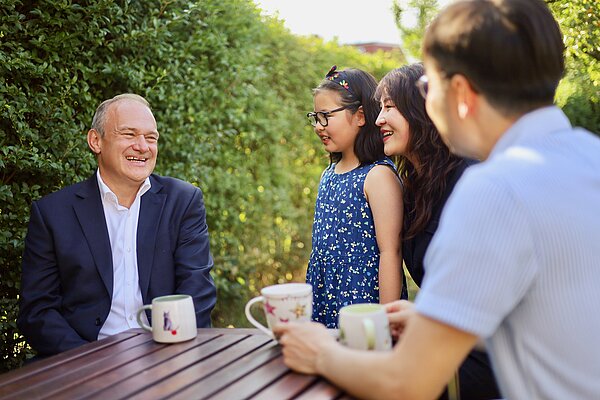 Ed Davey speaks to a family