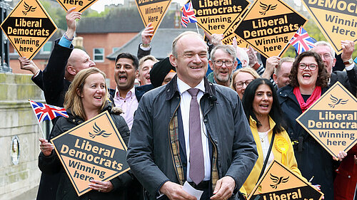 Ed Davey in front of crowd with Lib Dem diamond signs
