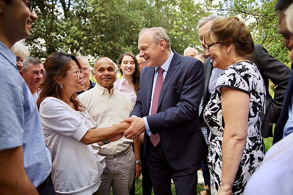 Ed Davey shakes hands with a woman