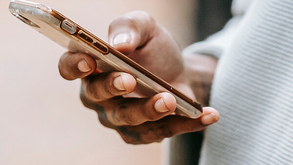 A hand holding a mobile phone