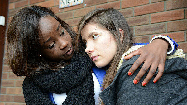 Woman comforting teenage girl