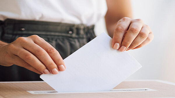 Federal Council 2025 Casual Vacancy A person putting a ballot paper into a ballot box