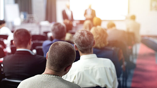 A group of people attending a training presentation