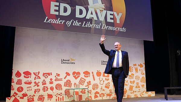 Ed Davey waves as he arrives on stage to make his keynote speech to Liberal Democrat Spring Conference 2025 in Harrogate